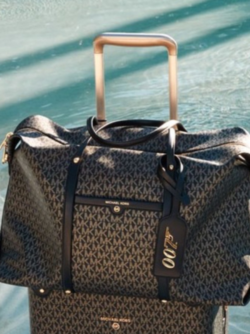 MICHAEL MICHAEL KORS
MMK x 007 Beck Extra-Large Metallic Logo Weekender Bag New